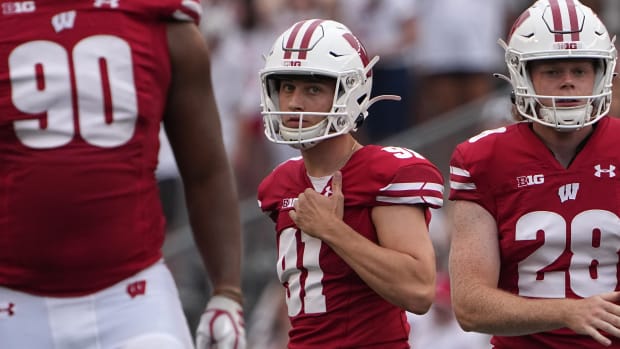 Wisconsin kicker Vito Calvaruso walking back to the sideline after missing a kick versus Washington State.